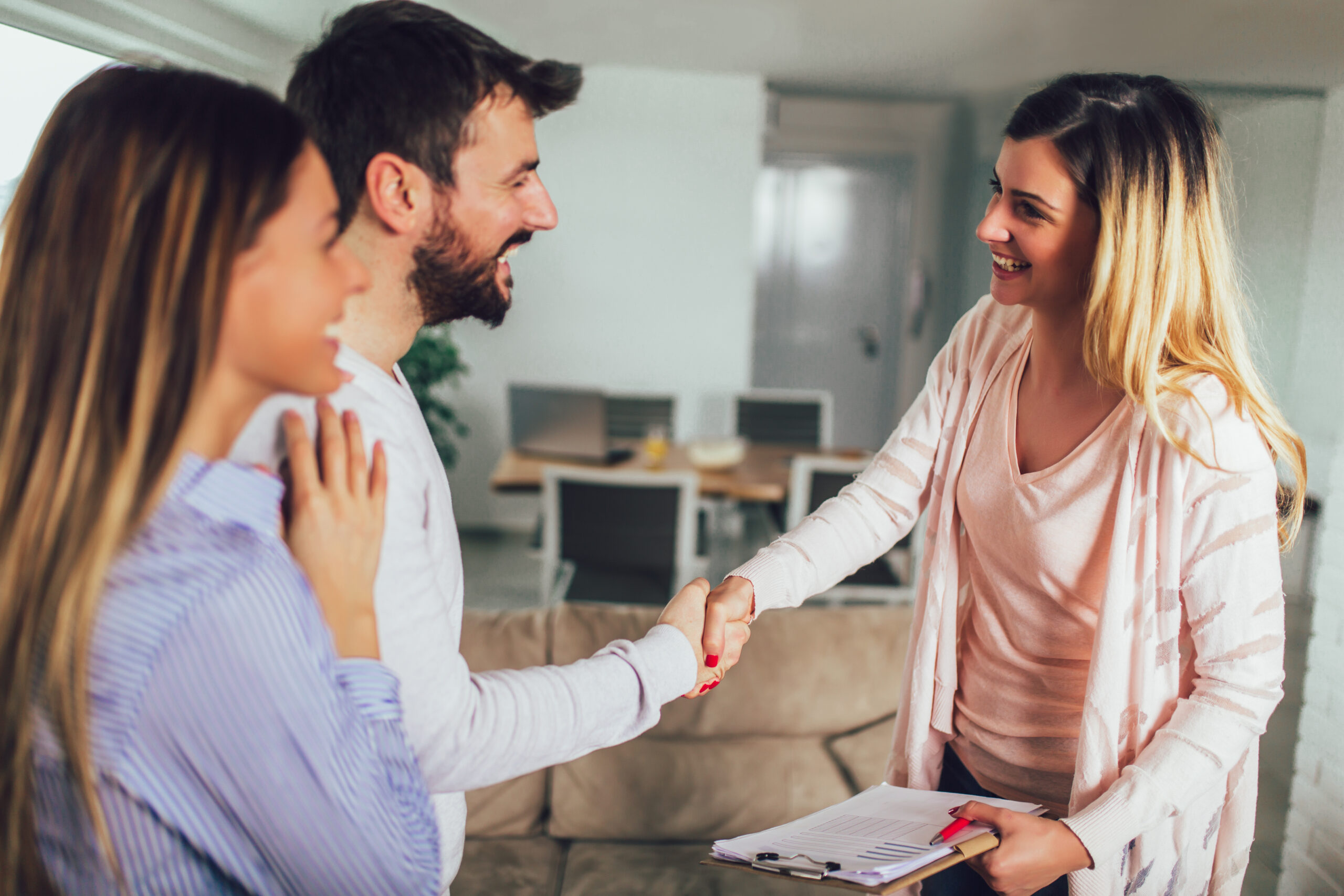 Real Estate agent shows interior to young couple