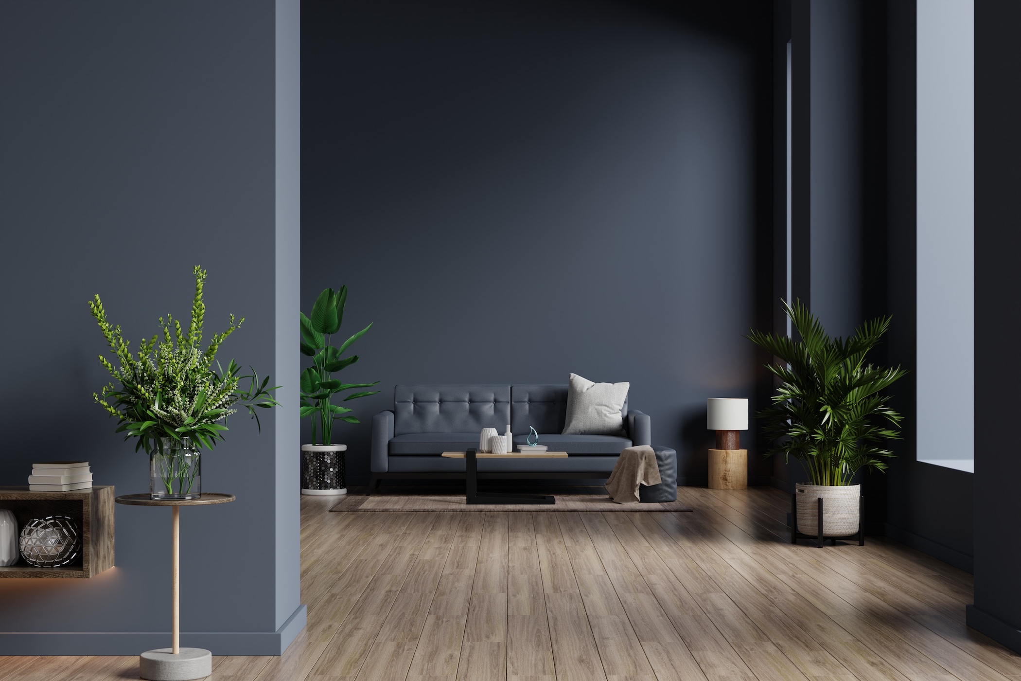 Interior of living room with sofa on empty dark blue wall background.